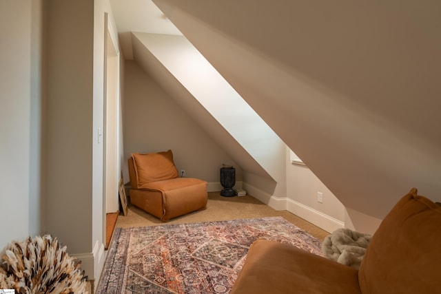 additional living space with lofted ceiling and light carpet