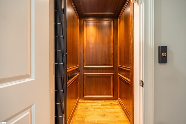 interior details featuring hardwood / wood-style flooring and elevator