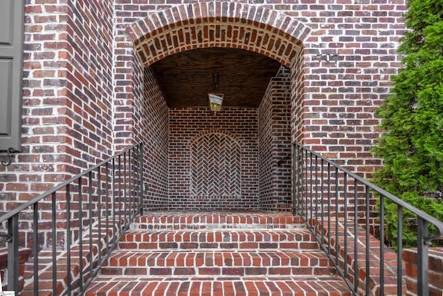 property entrance featuring brick siding