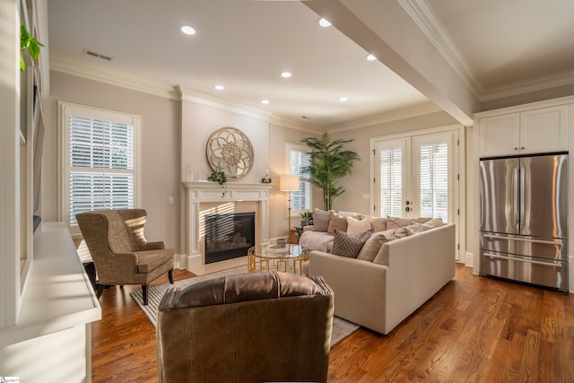 living room with a wealth of natural light, ornamental molding, dark hardwood / wood-style floors, and french doors