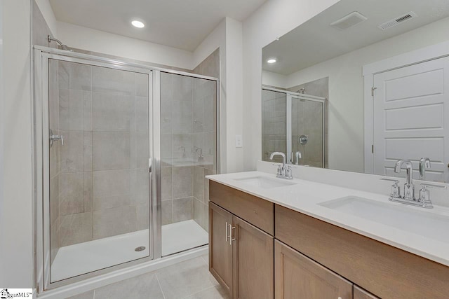 bathroom with vanity, walk in shower, and tile patterned flooring