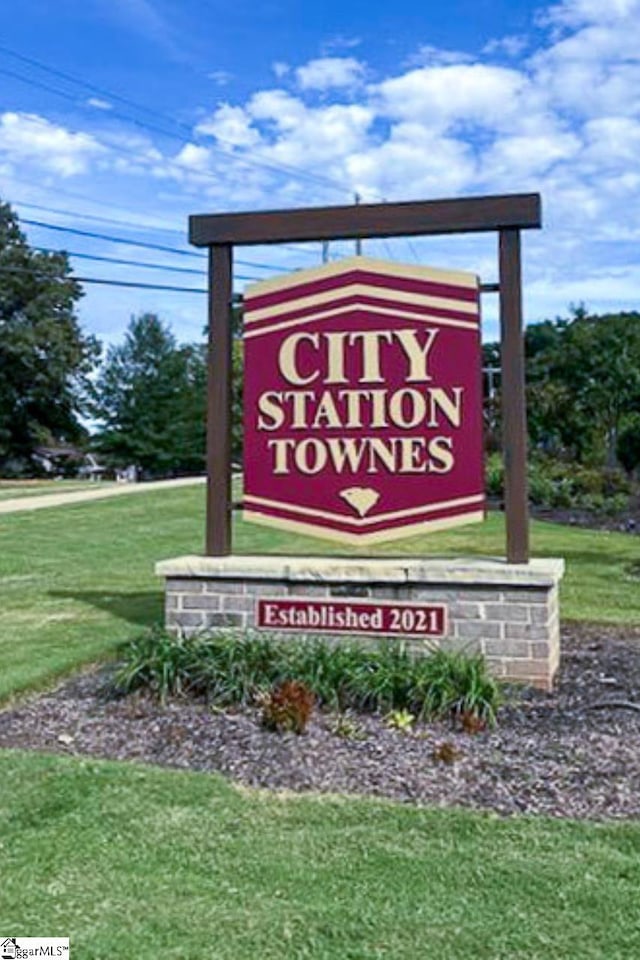 community sign featuring a lawn