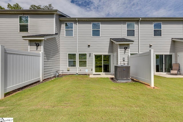 back of house with central AC unit, a yard, and a patio area