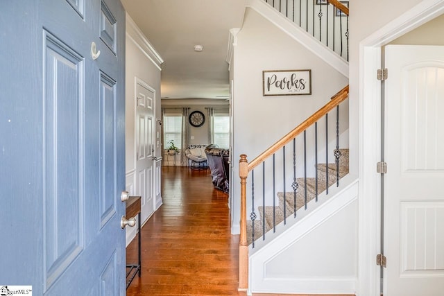 entrance foyer with dark hardwood / wood-style floors and ornamental molding