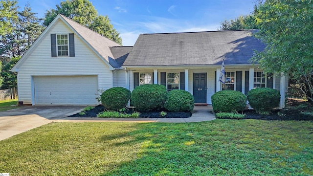 view of front of house featuring a front yard, covered porch, and a garage