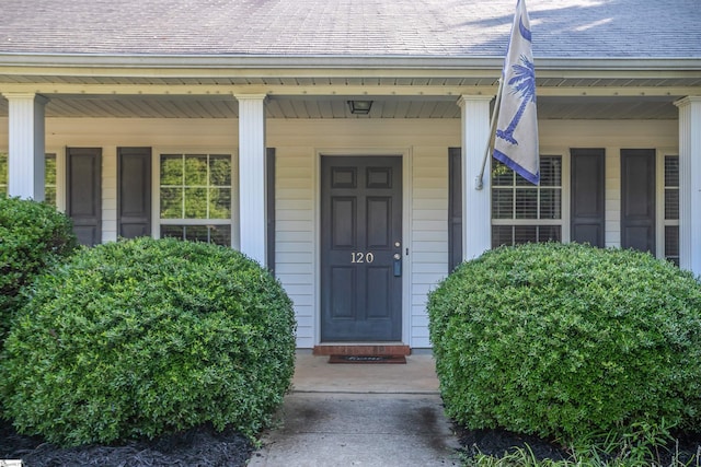 view of exterior entry with covered porch