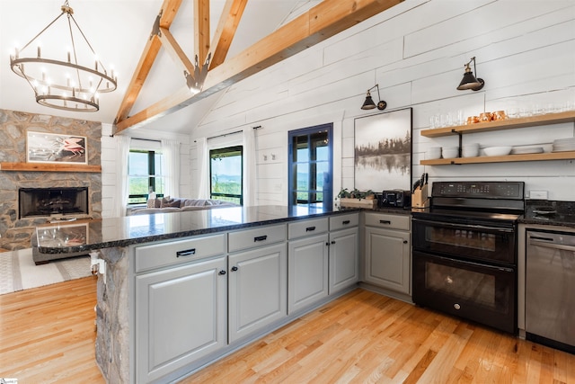 kitchen featuring dark stone countertops, lofted ceiling with beams, black range with electric stovetop, light hardwood / wood-style floors, and stainless steel dishwasher