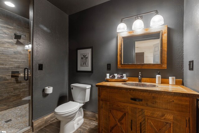 248 Bay View Dr, Salem, SC 29676 - bathroom with a shower stall, baseboards, toilet, wood finished floors, and vanity