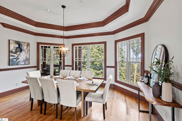 dining room with an inviting chandelier, light hardwood / wood-style floors, and ornamental molding