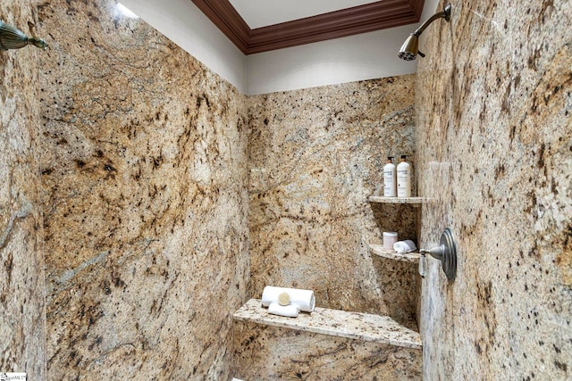 interior details with a shower and ornamental molding