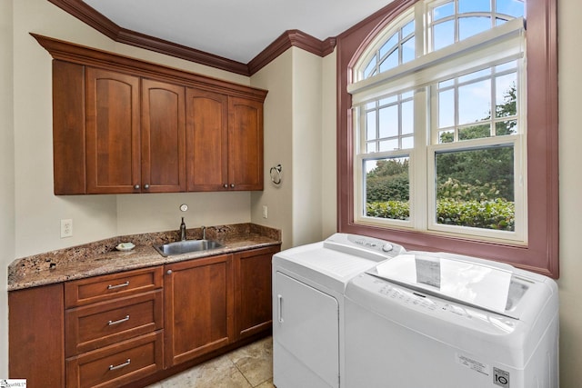 laundry area featuring cabinets, independent washer and dryer, ornamental molding, sink, and light tile patterned flooring