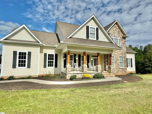 craftsman house featuring a porch and a front yard