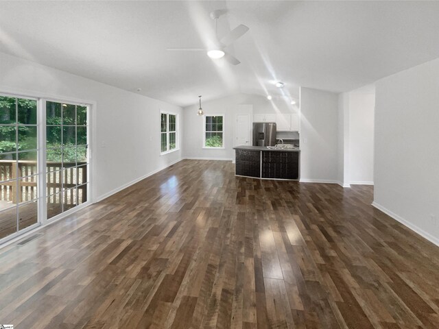 carpeted spare room with lofted ceiling and ceiling fan