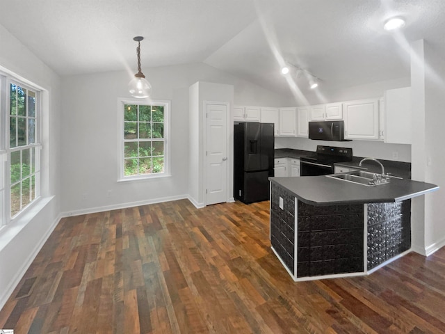 kitchen featuring black appliances, sink, hanging light fixtures, and dark hardwood / wood-style flooring