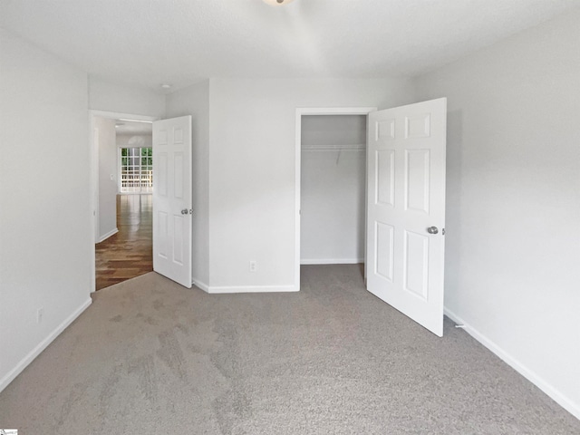 unfurnished bedroom featuring a closet and carpet