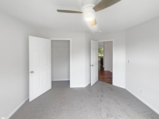 unfurnished bedroom featuring carpet floors, ceiling fan, and a closet