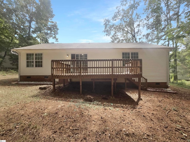 back of property with a wooden deck