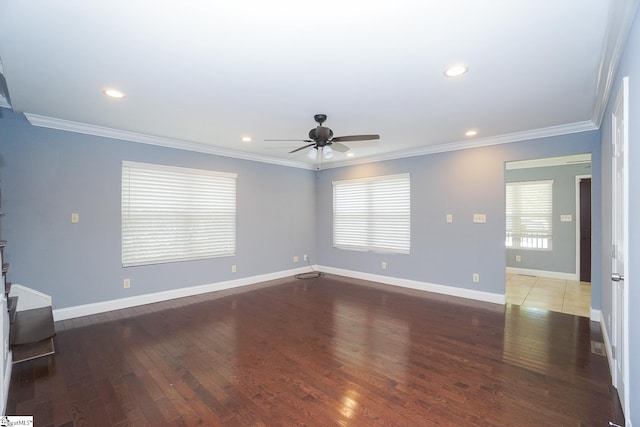 unfurnished living room featuring dark wood-type flooring, ceiling fan, a wealth of natural light, and ornamental molding