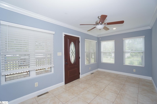 tiled entrance foyer featuring ceiling fan and crown molding