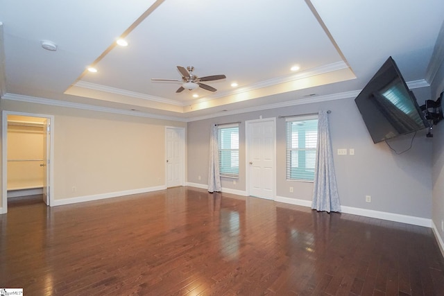 interior space with crown molding, a raised ceiling, ceiling fan, and dark hardwood / wood-style floors