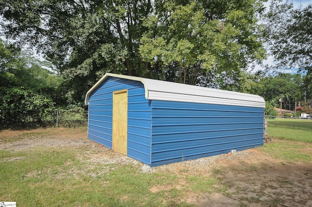 view of outbuilding with a lawn