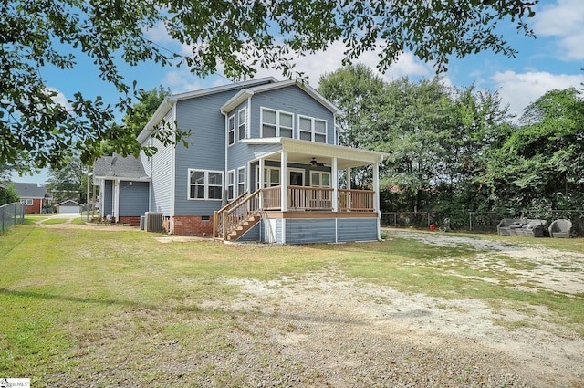 rear view of property featuring central air condition unit, ceiling fan, and a yard