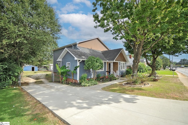 view of front of house featuring a garage, a front yard, and a porch