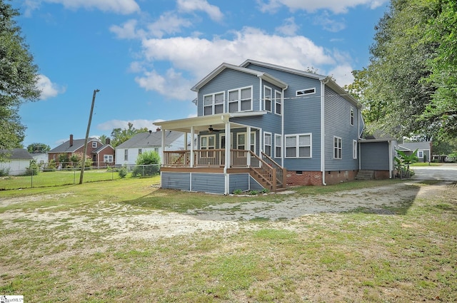 rear view of property featuring a yard