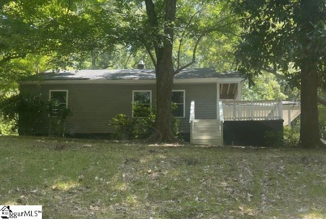 exterior space with a yard and a wooden deck