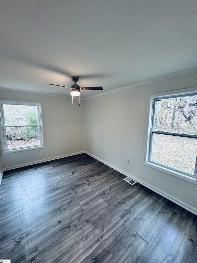 unfurnished room featuring crown molding, ceiling fan, a healthy amount of sunlight, and dark hardwood / wood-style floors