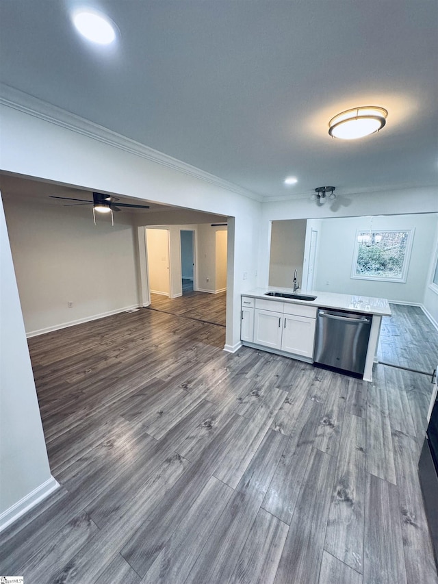 kitchen with dark hardwood / wood-style flooring, white cabinets, ornamental molding, sink, and dishwasher