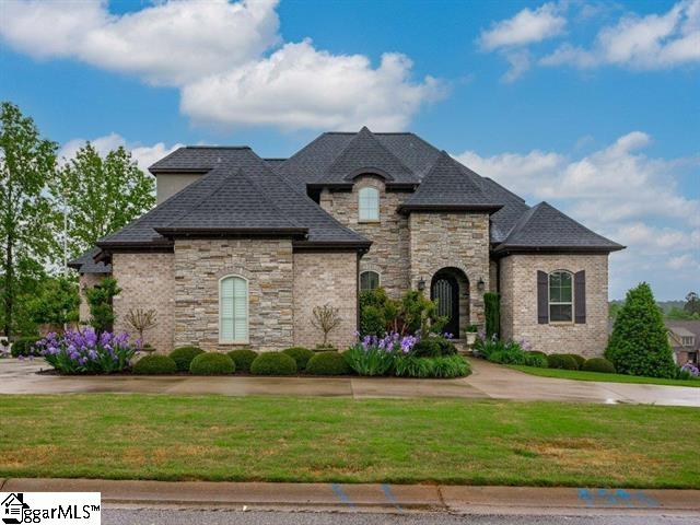 french country style house featuring a front yard