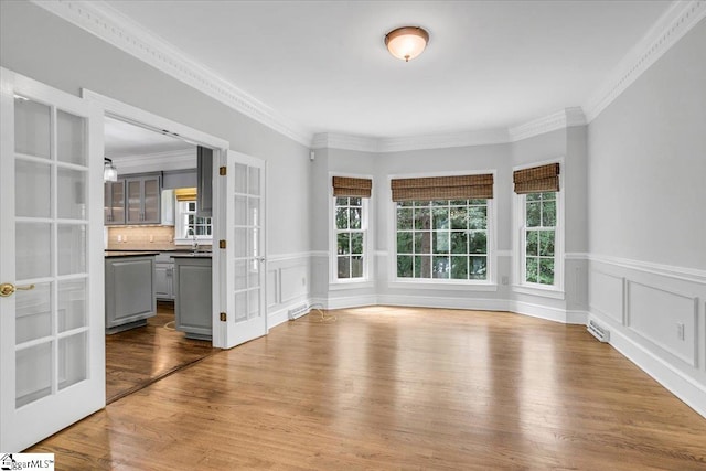 interior space with hardwood / wood-style floors, crown molding, and sink