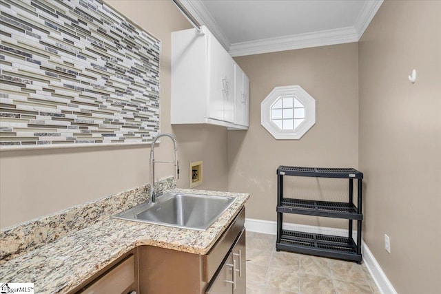 laundry area with washer hookup, ornamental molding, cabinets, and sink