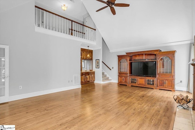 unfurnished living room featuring ceiling fan, high vaulted ceiling, and light hardwood / wood-style floors