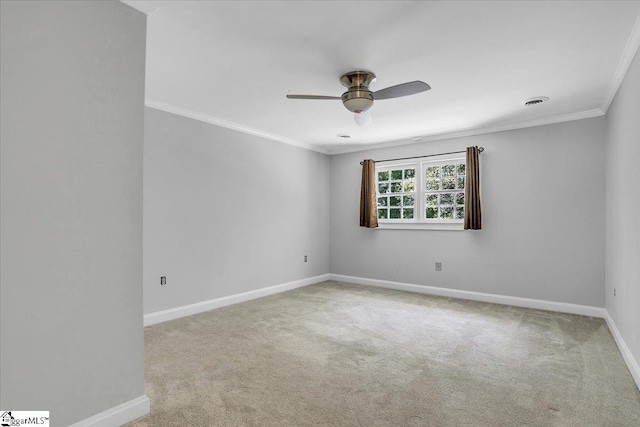 carpeted spare room featuring ornamental molding and ceiling fan