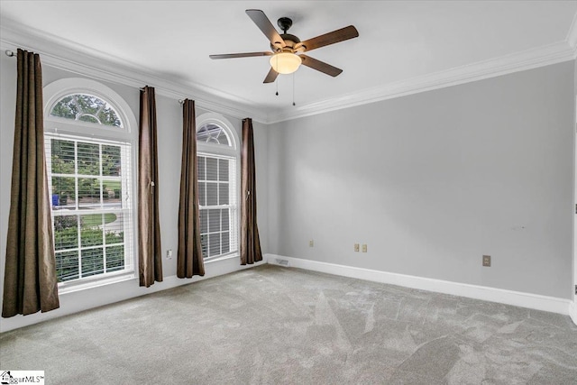 carpeted empty room featuring ornamental molding and ceiling fan