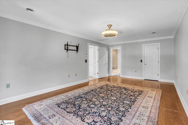 foyer entrance featuring crown molding and hardwood / wood-style flooring