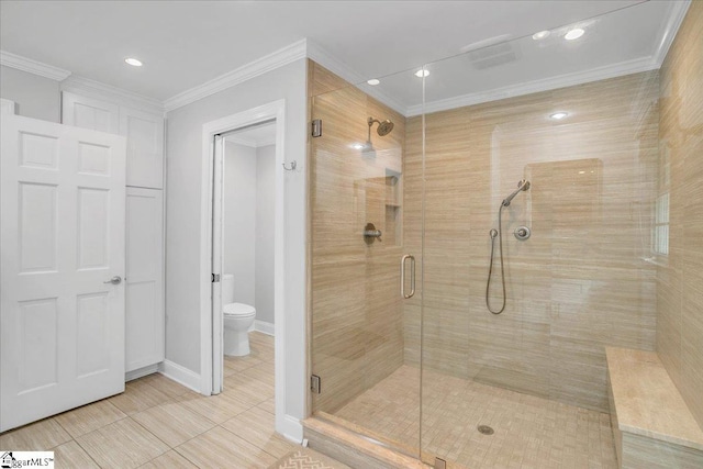 bathroom with walk in shower, toilet, crown molding, and tile patterned flooring