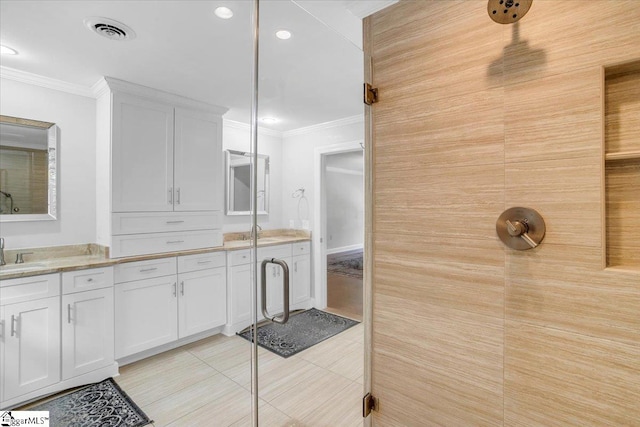 bathroom featuring crown molding, vanity, and tile patterned floors