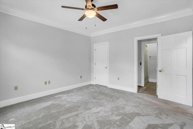 unfurnished bedroom with light colored carpet, ceiling fan, and ornamental molding