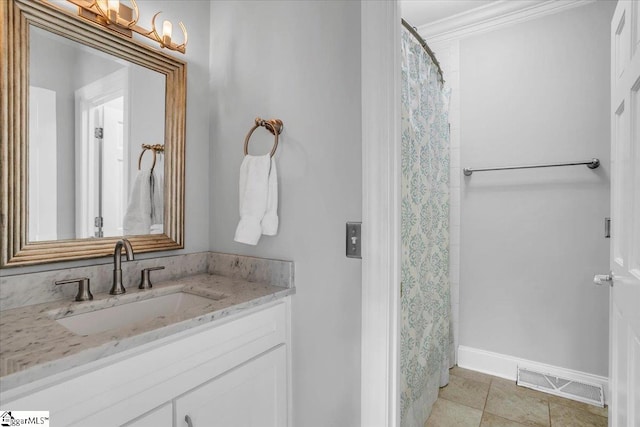 bathroom featuring vanity, ornamental molding, tile patterned floors, and walk in shower