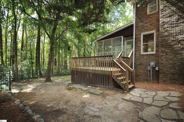 view of yard with a wooden deck and a sunroom