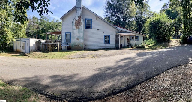 view of home's exterior featuring a shed