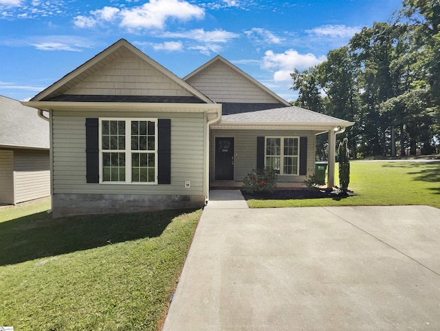 view of front of property with a shingled roof and a front lawn