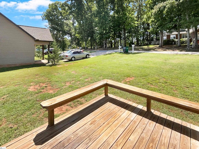 wooden terrace with a lawn