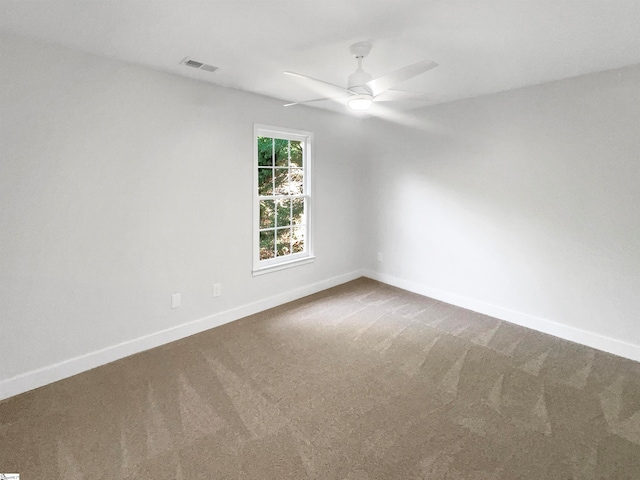 spare room featuring ceiling fan and carpet floors