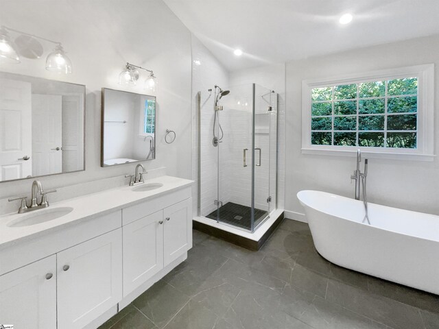 bathroom with vanity, a healthy amount of sunlight, and shower with separate bathtub