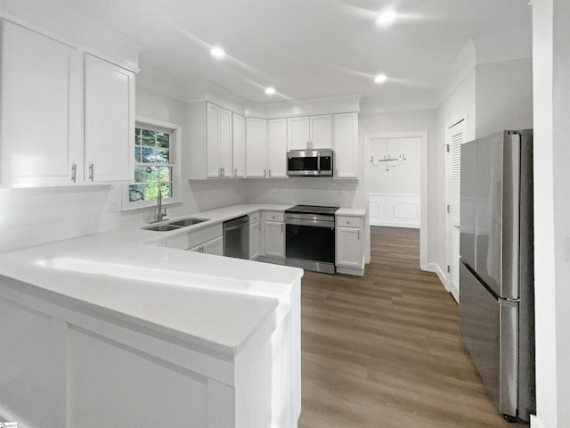 kitchen featuring a sink, stainless steel appliances, light countertops, white cabinets, and light wood-type flooring