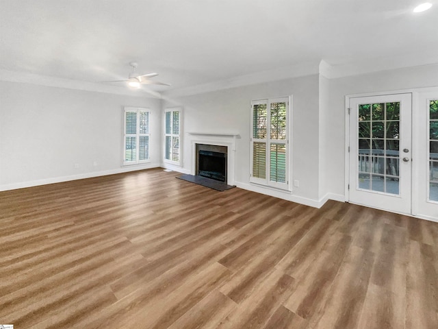 unfurnished living room featuring ceiling fan, a high end fireplace, and hardwood / wood-style floors